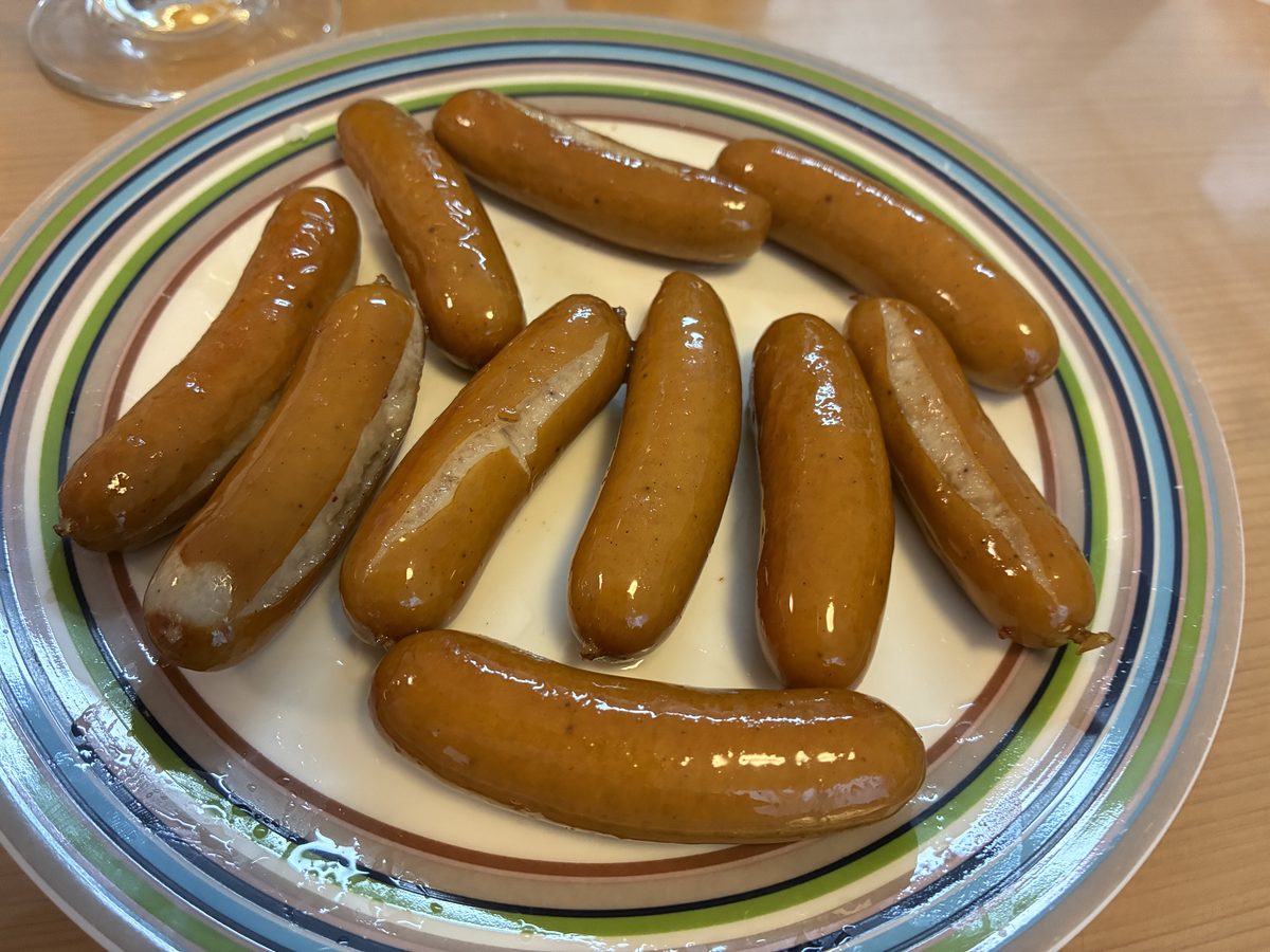 ボイルしてから焼いたサイトウハムのポリポリくん10本を皿に盛ったところ 全体に茶色い